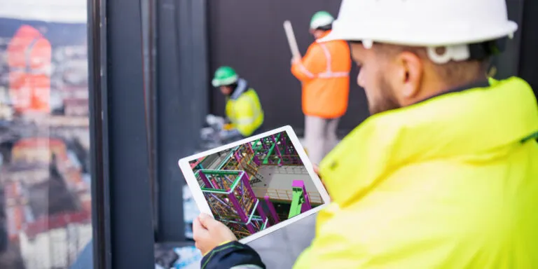 Contractors coordinating construction activities using BIM models.